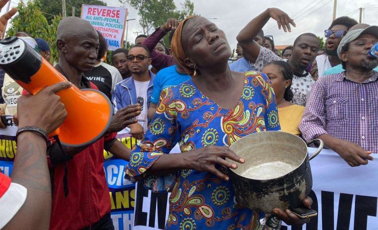 Hungry Woman Protests With Empty Pot In Lagos